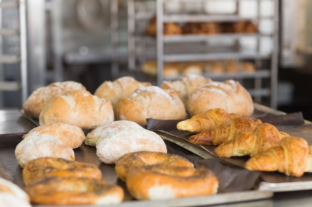 Freshly baked bread on counter in the kitchen of the bakery.jpeg Freshly baked bread on counter in the kitchen of the bakery.jpeg