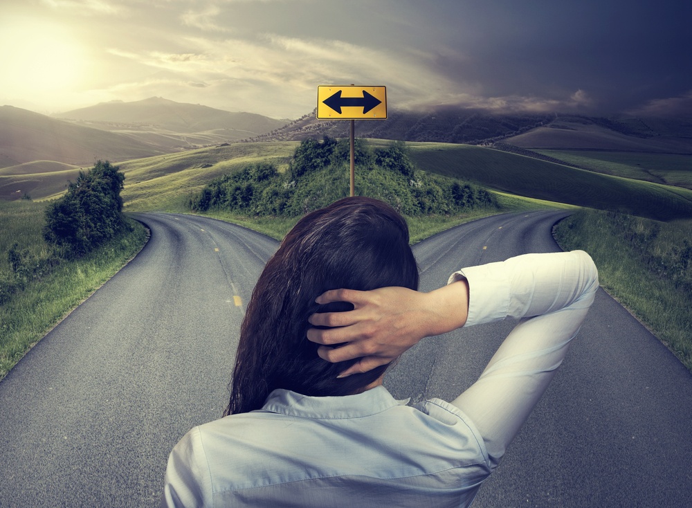 woman in front of two roads deciding which industrial mixer to choose woman in front of two roads deciding which industrial mixer to choose
