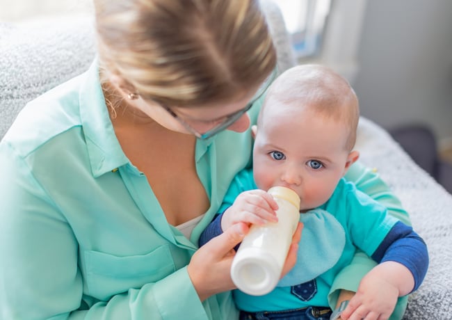 Cute baby brinking from a bottle Cute baby brinking from a bottle